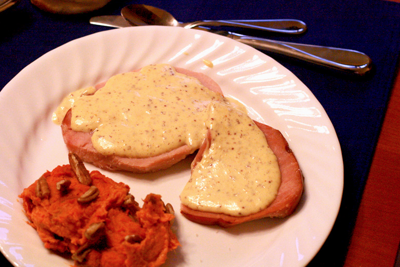 Easter dinner of ham with deviled egg sauce and mashed sweet potatoes