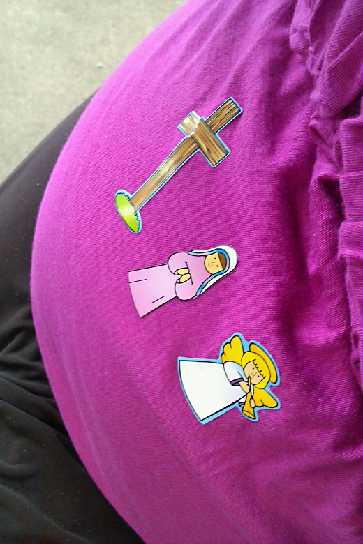 pregnant belly being used as flannelgraph for church stickers