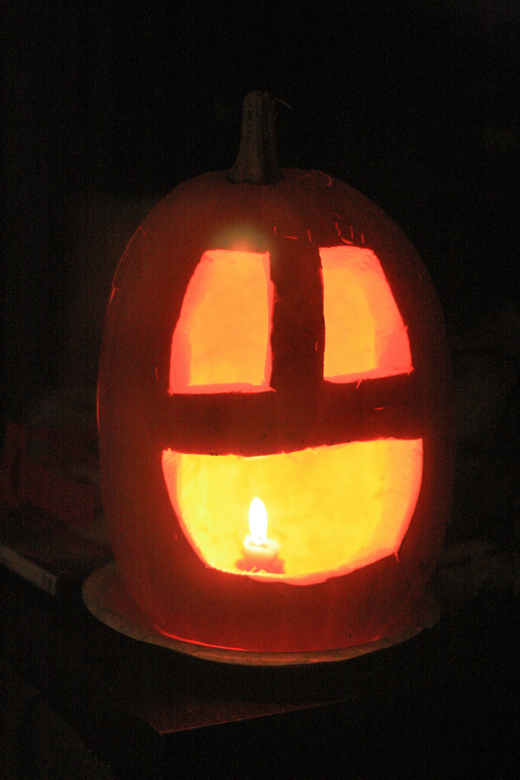 happy pumpkin jack-o'-lantern lit