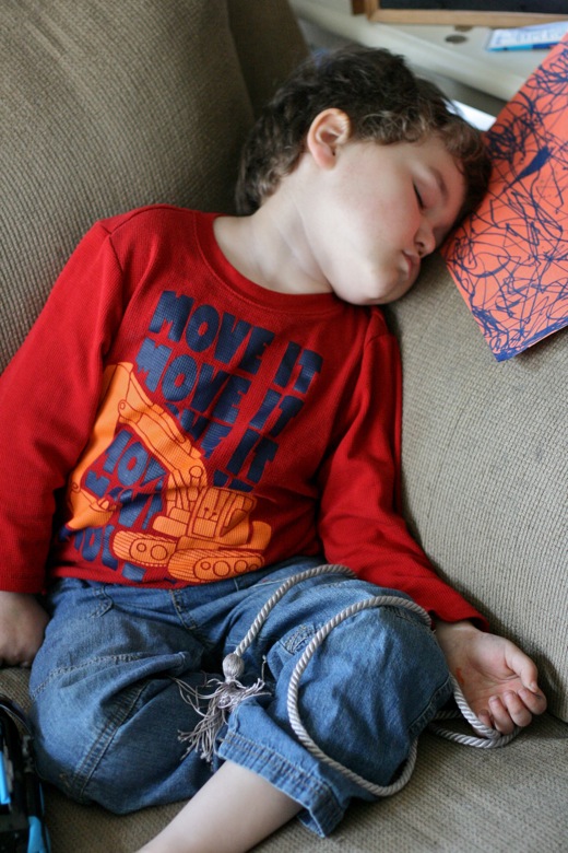 preschooler boy napping on the couch sitting up