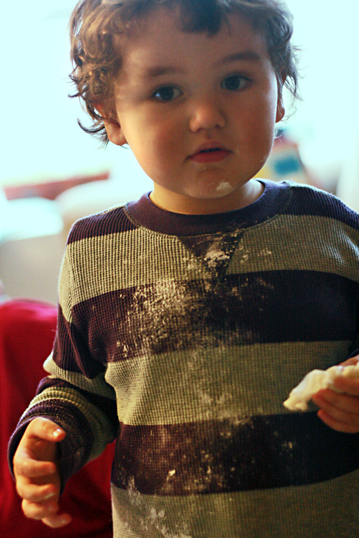 boy with powdered sugar all down his shirt