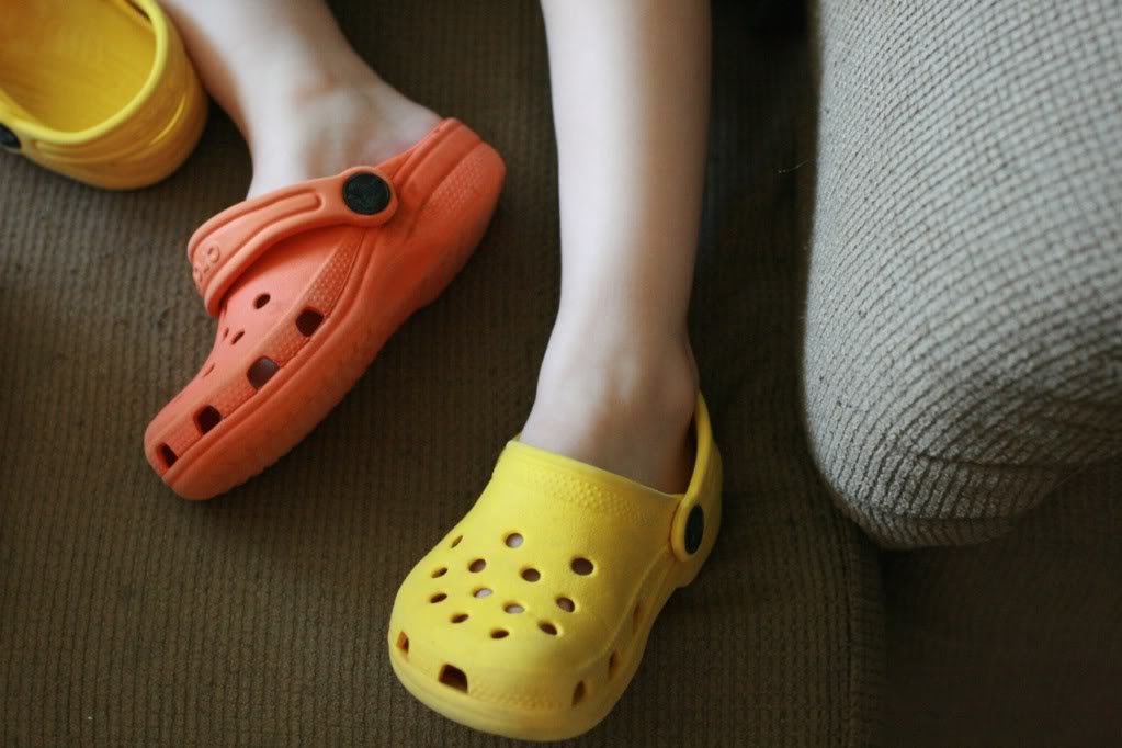 two different colored crocs on toddler