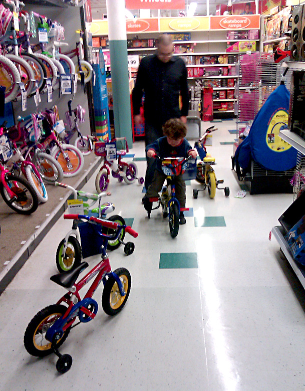 trying out children's bicycles at the toy store